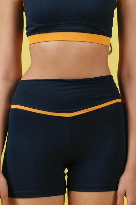 Navy athletic outfit with yellow accents on a yellow background